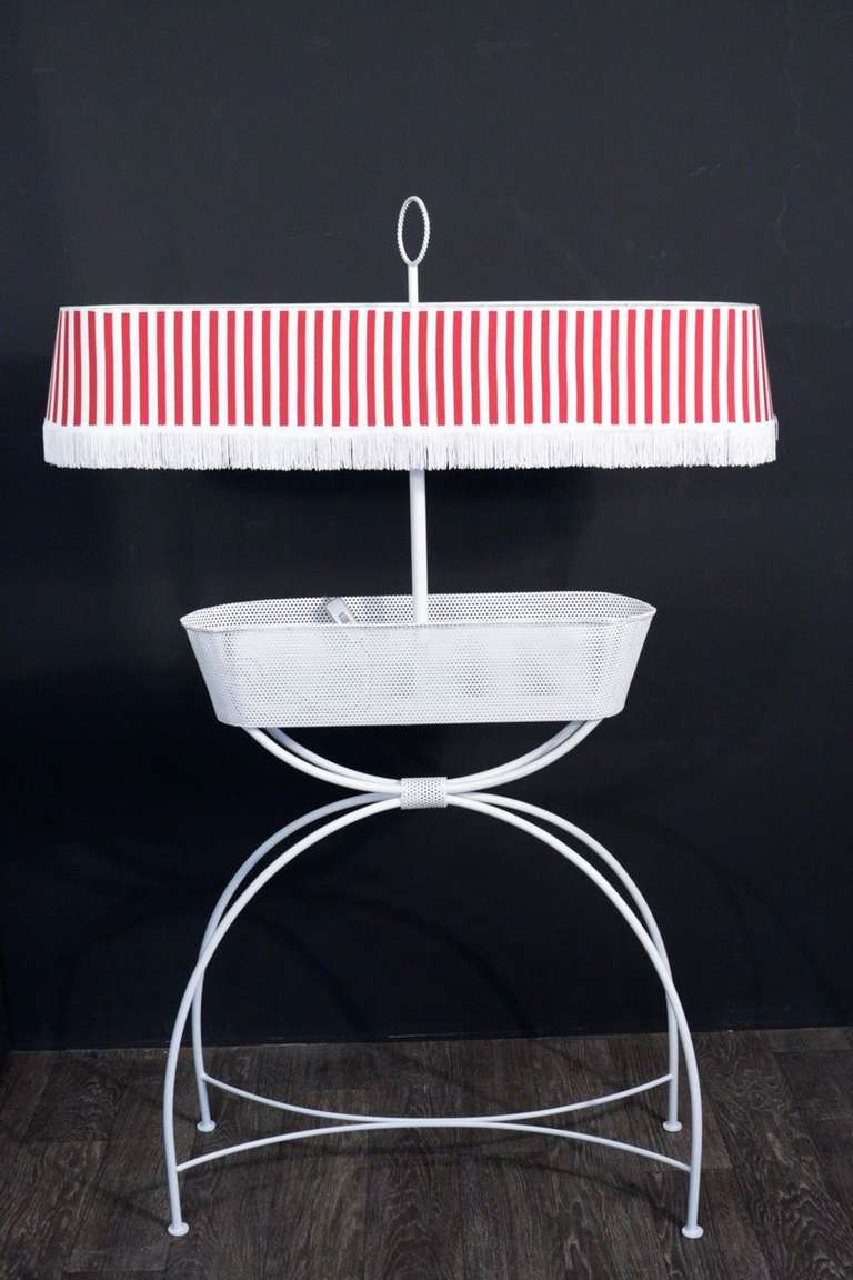 1950s garden box and bottle holder floor lamp by Mathieu Matégot. 
Perforated sheet steel. Originally designed for the garden furniture of the Seine river restaurants. 1951. 
New shade redone according to the original. Two bulbs.