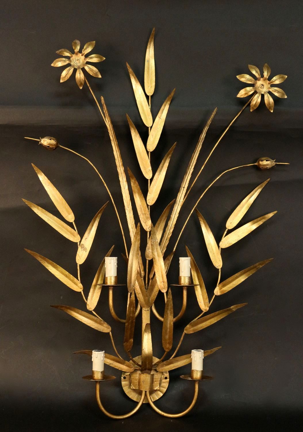 Large pair of 1960's 'Daisies' sconces by Maison FlorArt in gilt iron composed of foliage, daisy flowers and buds. Part of a series with item number LU98581856672. Four lighted arms per sconce.