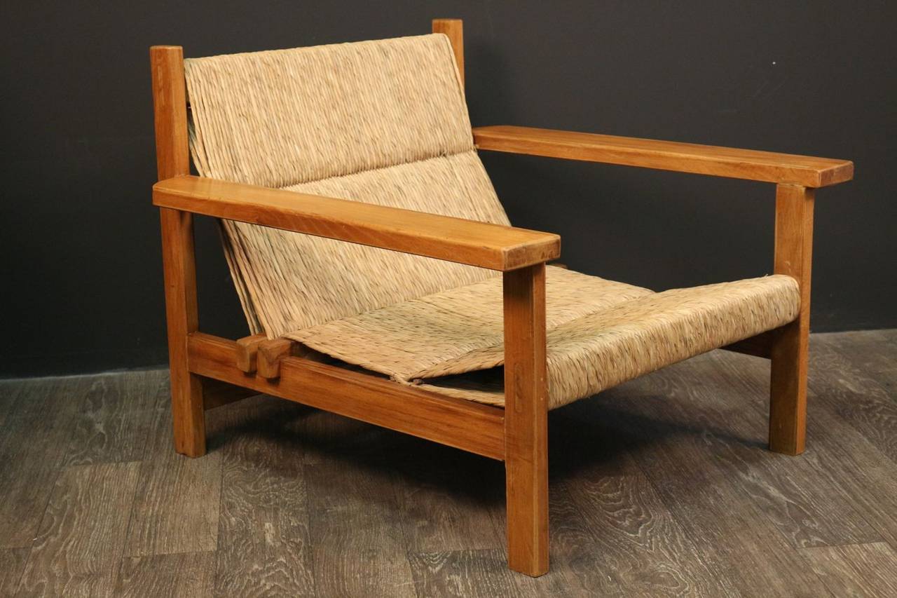 Pair of large 1940s armchairs attributed to Francis Jourdain.

Covered structure with wide armrests, backrest and seat are covered with original caning in perfect condition.

Set of 2 pairs of armchairs. Second pair listed on the website under