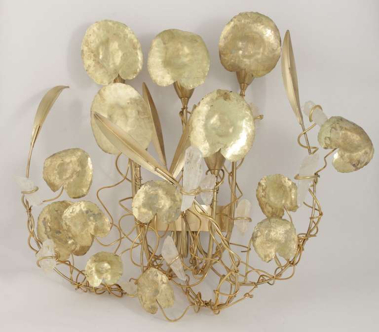 Large pair of rock-crystal and brass sconces by Robert Goossens. Five lights per sconce hidden under the leaves. The rock-crystal is rolled on a brass wire that runs over the sconce.