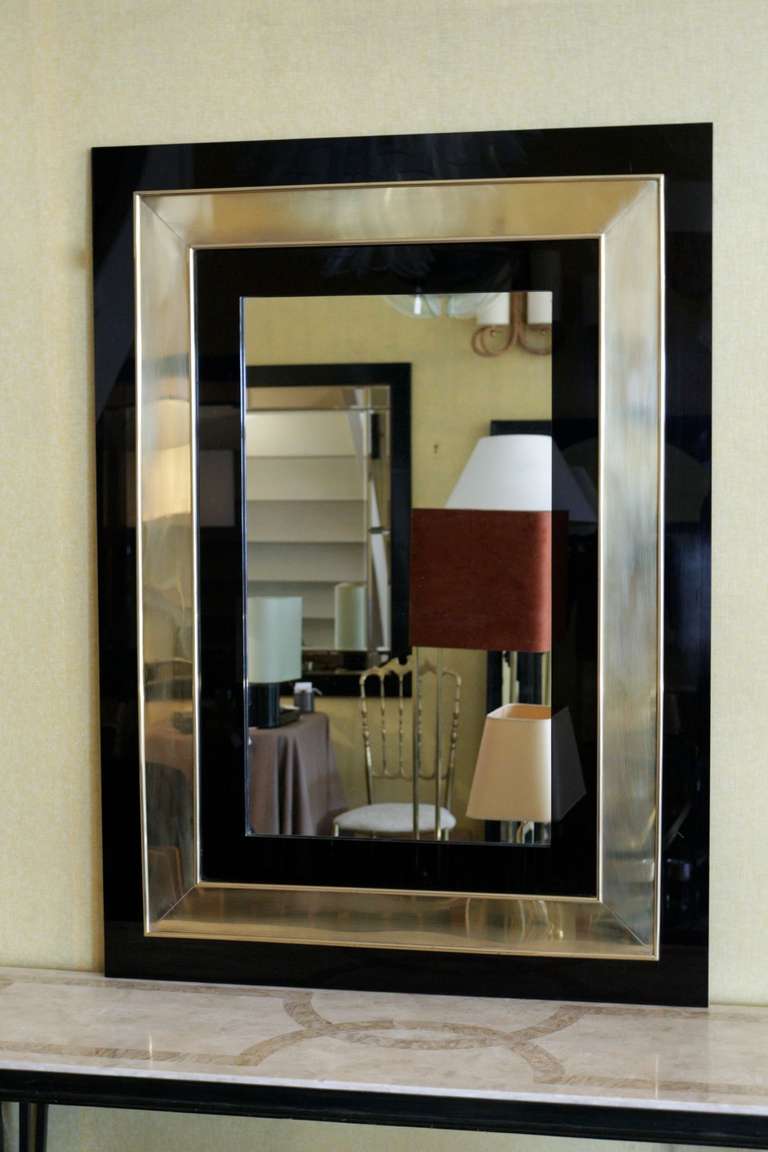 1970s mirror with a plexiglass frame outlined with brass. 
Original mirror.