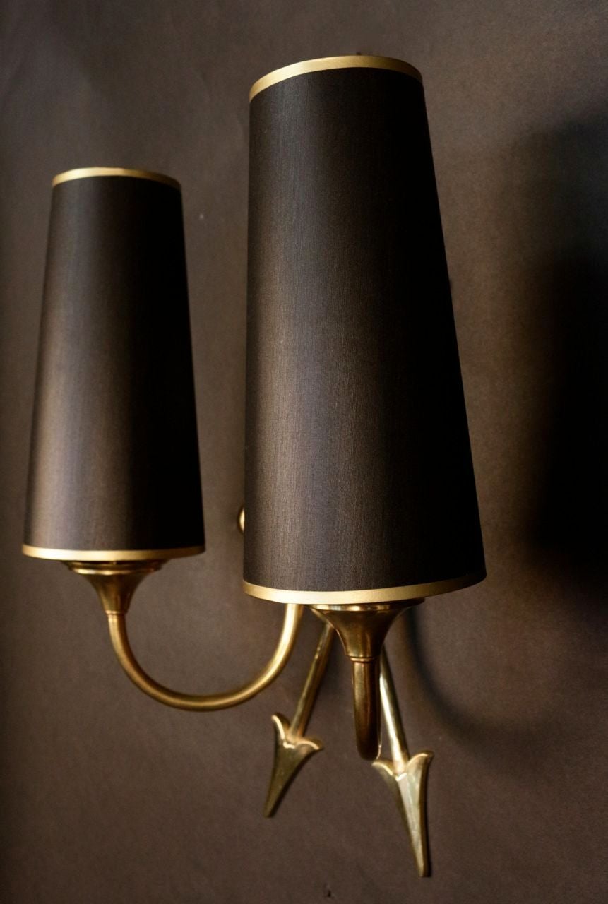 Pair of 1950s Directoire inspiration sconces by Maison Lunel.
Gilt and blackened brass with two gilt arrows and double lighted arm. Black color outside and gold color inside lampshade.