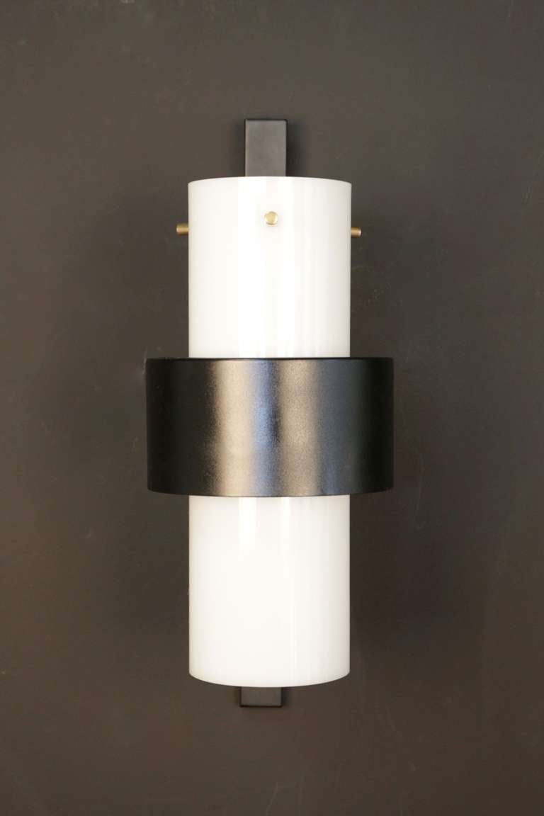 Pair of 1960s sconces by Maison Lunel in Perplex tube mounted on brass axes. Sheet steel cylinders are enhanced with Altuglas. One light per sconce.