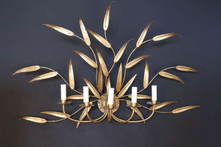 Large pair of 1960s sconces. Five lighted arms and seven gilded sheet steel branches with leaves.