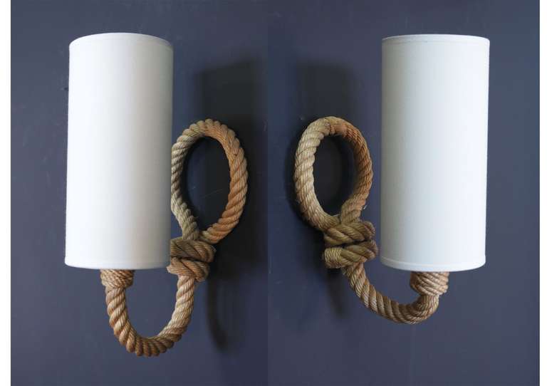 Pair of 1950s sconces by Audoux-Monet. Slight height difference between the two sconces. One bulb per sconce. New shade.