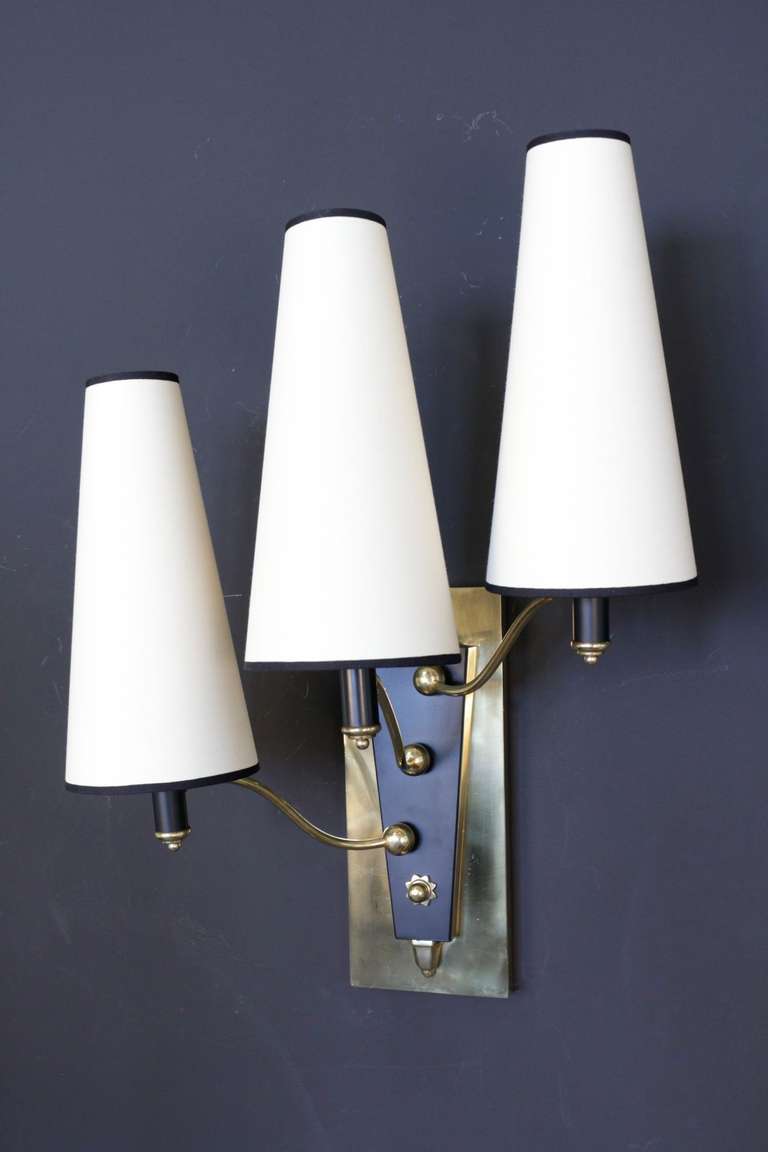 Set of three 1950's large sconces in gilded and blackened brass decorated with a little sun. From the Lutetia Hotel Paris. 
Three lighted arms per sconce. New custom lampshade.