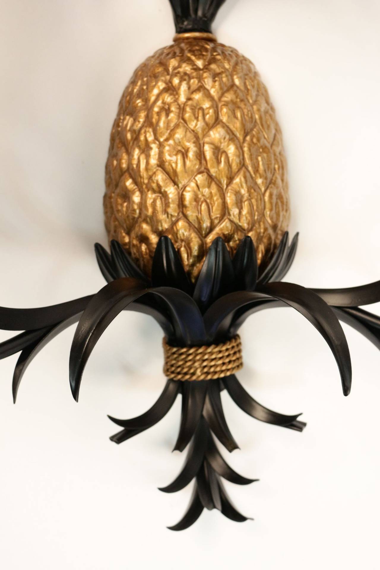 Pair of large 1970s sconces 'The Pineapples' by Maison FlorArt.

The pineapple is in gilt earthenware, the foliage in blackened sheet metal.
Two lighted arms surmounted by tailored lampshades with gold color inside and black outside.