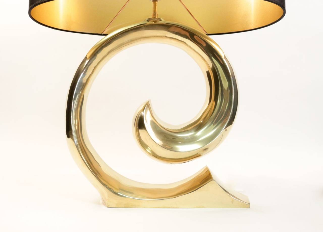 1970s table lamp 'The Wave.' Beautiful bronze piece. Oval tailored lampshade with gold color inside and black outside. One lighted arm.