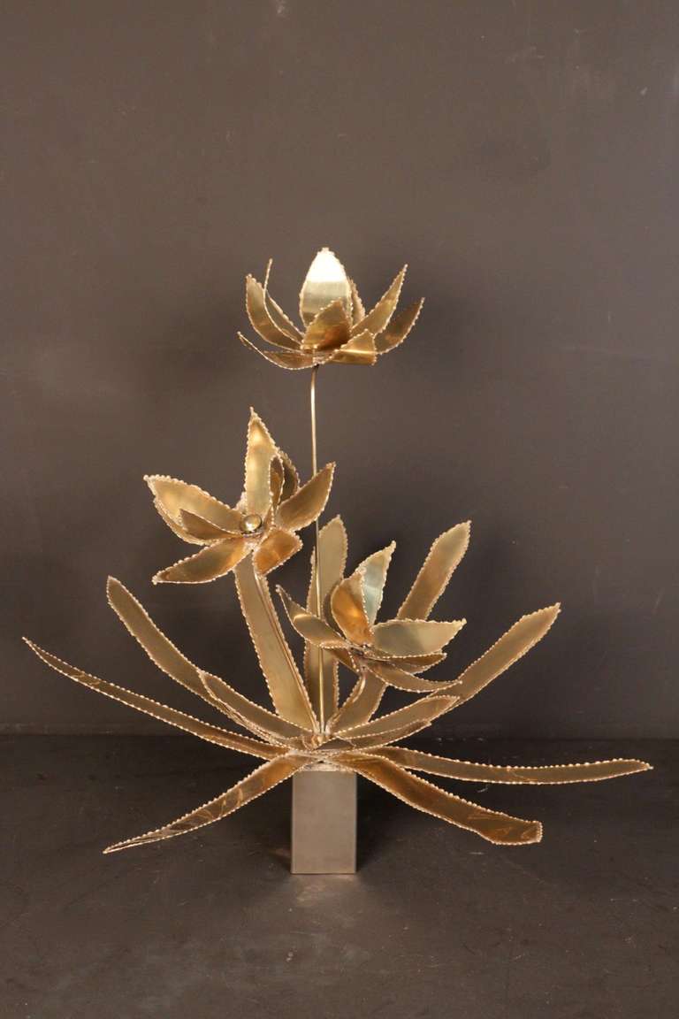1970s brass sculpture by Maison Honore. Composed of three large flowers and a set of nine large leaves and five young shoot in gilded brass. Silvered brass base.