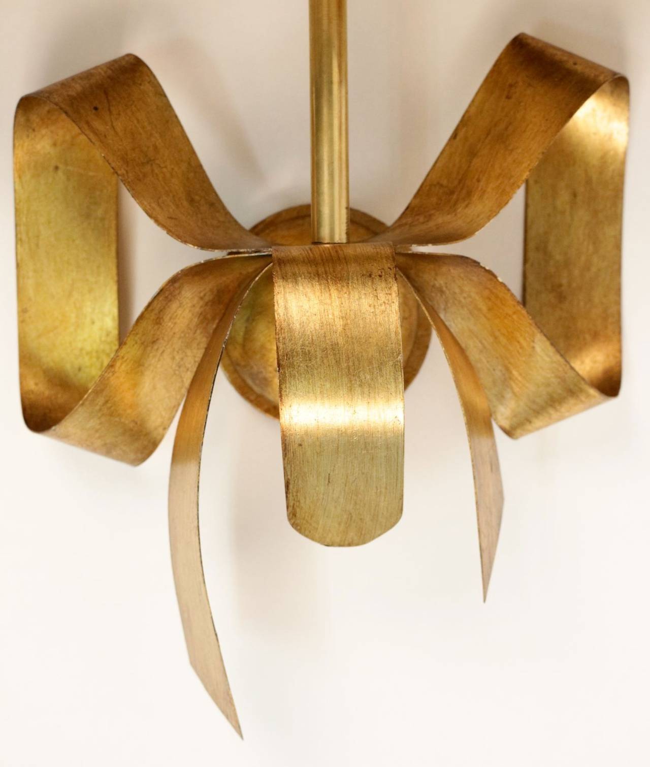 Pair of 1970s 'Pretty Knot' model sconces by Maison FlorArt.
The large knot is in gilt sheet metal. Tailored lampshade with three faces. Rectangular shape. Gold color inside and black outside. One lighted arm per sconce.