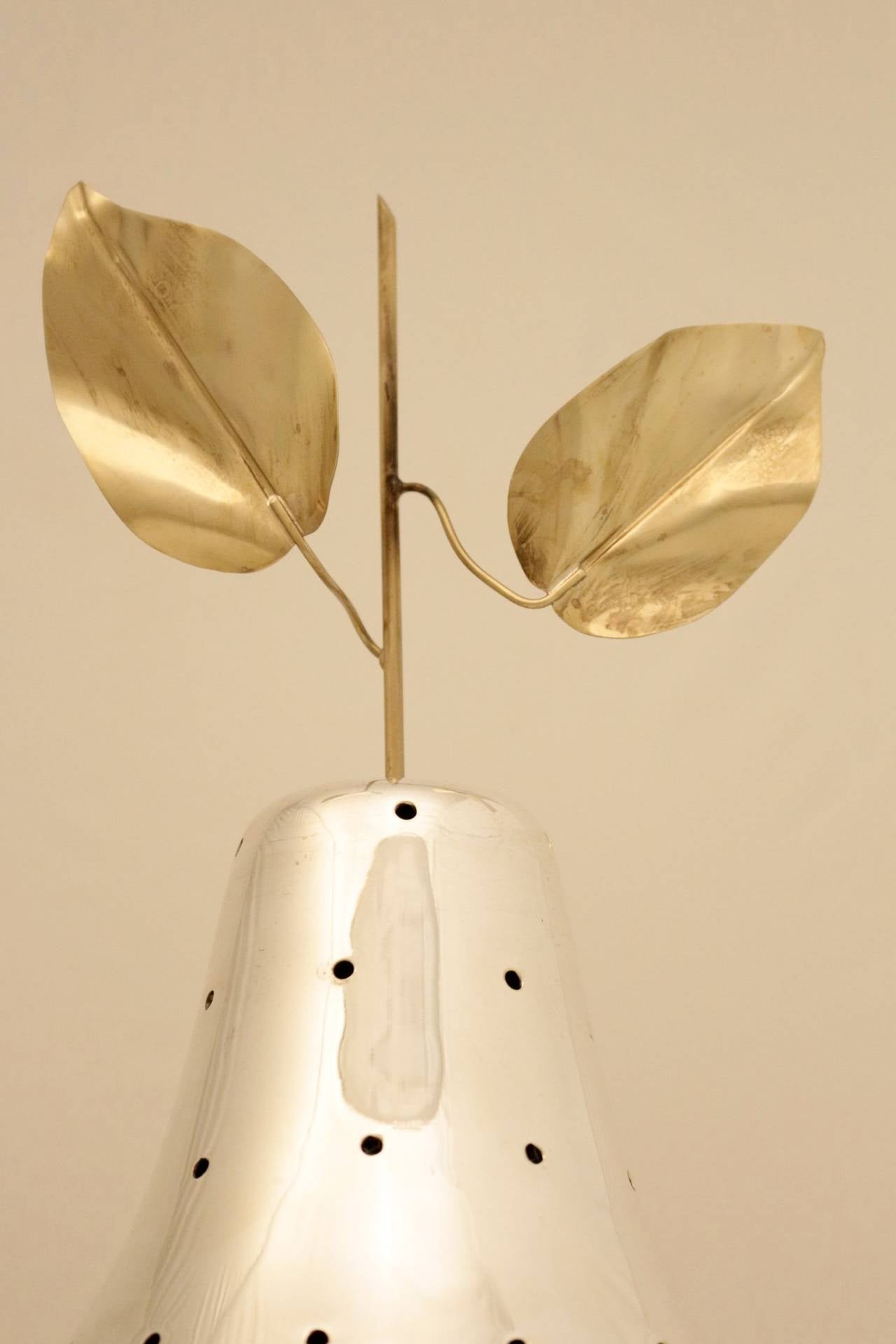 1970s 'Pear' cocktail stand. Decorative and useful object. 
The pear shaped body is decorated with regular holes serving as holders for cocktail picks for fruits or other food. 
One rod and two leaves in gilt brass embellishes the pear. 
The pear