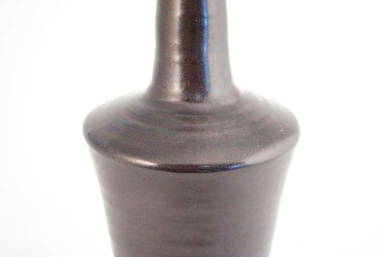 Enameled stoneware bottle, dark brown bottom with purple glaze,white stoneware bottle-neck,  signed by Marcel Guillot, 1950. Good condition.