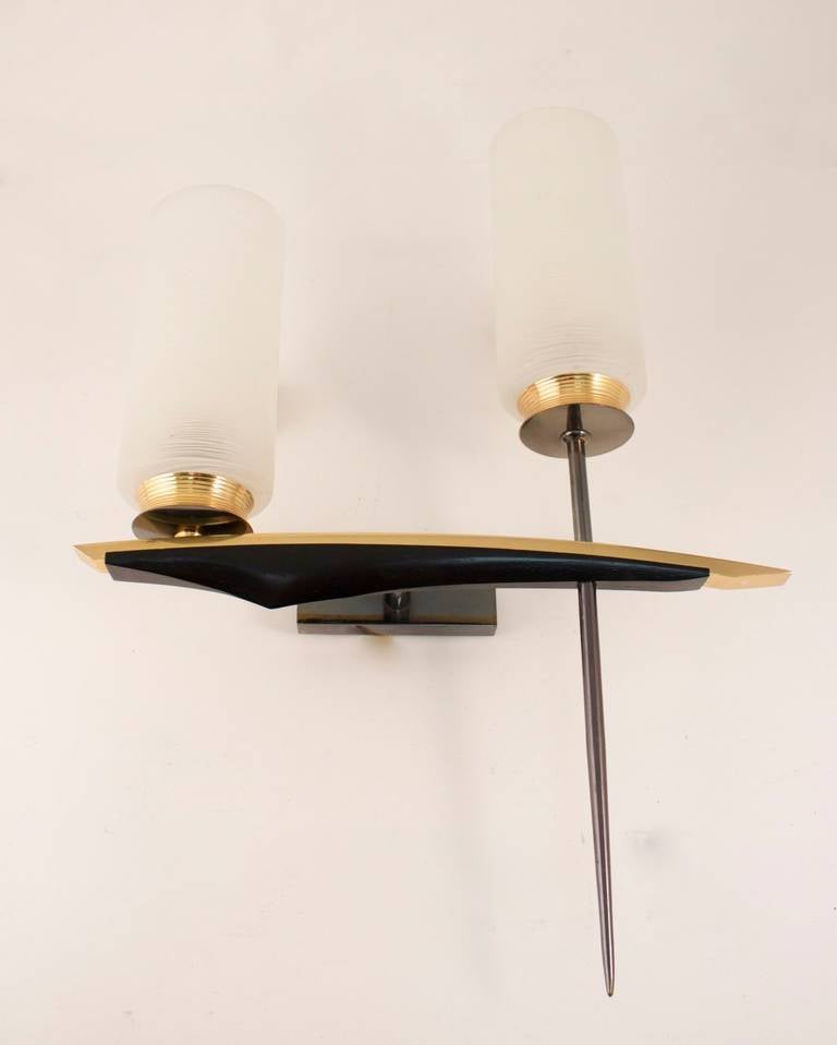 Pair of 1950s asymmetric sconces by Maison Arlus.  
Natural color and 'canon de fusil' brass highlighted by a black lacquer bar. 
Two opaline and two lighted arms per sconce.