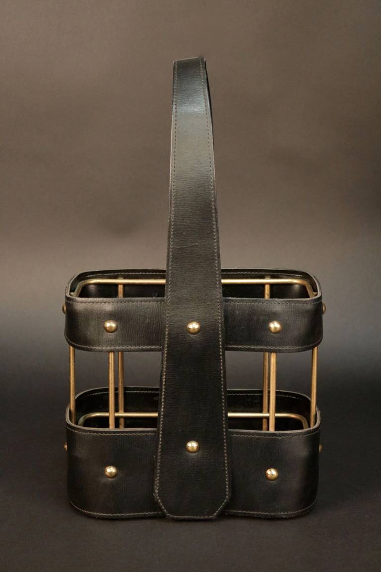1960s bottle holder by Jacques Adnet Compagnie des Arts Français in black stitched leather decorated with brass nails. Brass structure.