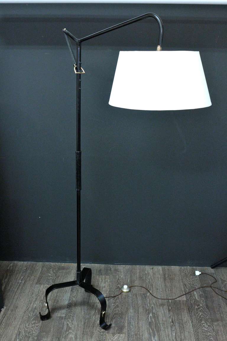 1946 Clamp Lamp by Jacques Adnet. Adjustable height with a bronze clamp and a leather strap. The trunk is enhanced by a stitched leather finish. Ball-mounted shade entirely redone according to the original. Good condition.