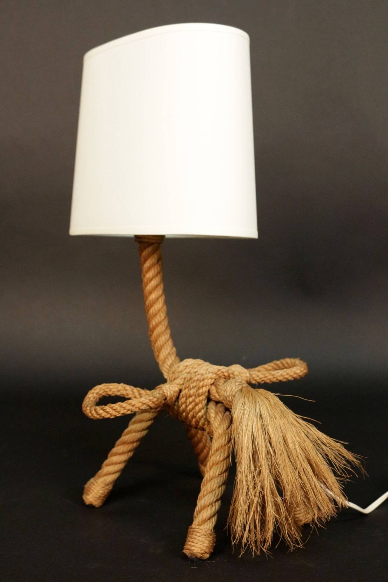Pair of 1950s 'Small Horse' table lamps by Adrien Audoux and Frida Minet in rope.

Hemp plumed tail adorned with two small rope baskets. One lighted arm and new lamp shade.