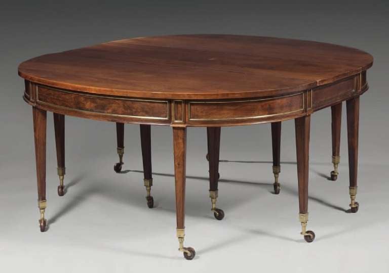 A very Fine 18’century  French  Oval Extending Walnut   Dining- Table , with brass- mounted paneled frieze   and four extentions . legs ending in capes and casters.
Measurments  
HIGHT; cm 75
WIDTH; cm 125 + 4 x cm 45 Leaves ;Fully extended  cm
