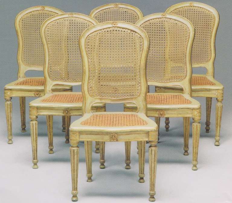 A fine set of six Italian, 18th century green-painted and parcel-gilt chairs.