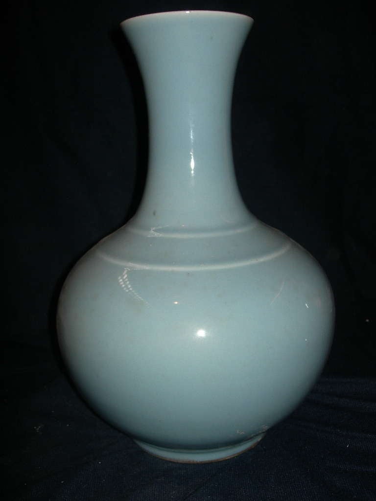 A light blue-glazed porcelain bottle vase underglaze blue, six character seal mark Qianlong and period .