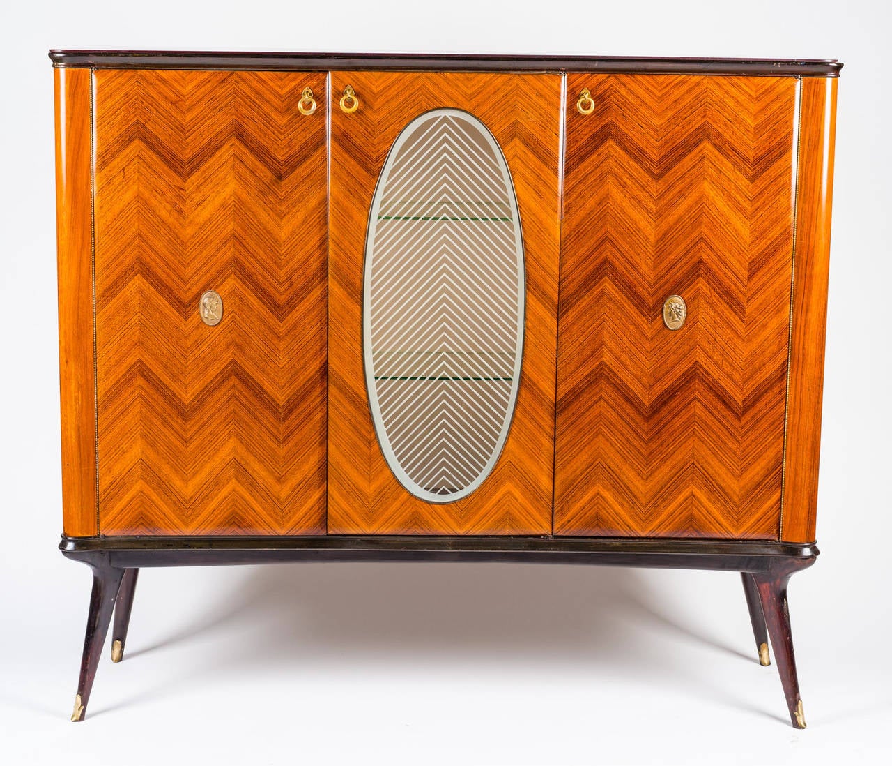 Adorable bar cabinet in rosewood designed by Paolo Buffa. The lines of the central glass continue those of the two doors.