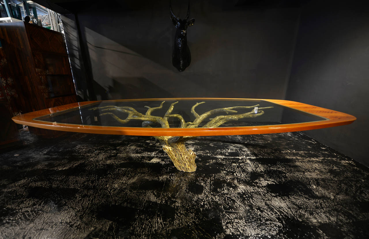 Sculptural bronze tree and mahogany marquetry dining table.
The size is pretty big, the marquetry work is exceptional, it seems that the glass is floating over the tree.
