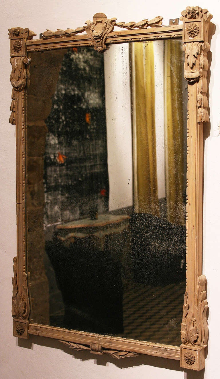 Beautiful Louis XVI trumeau mirror, France, eighteenth century. The frame is finely crafted, raw wood. Antic mirror whose silvering is dived and weathered by times. Such a nice item, to present with its matching console.