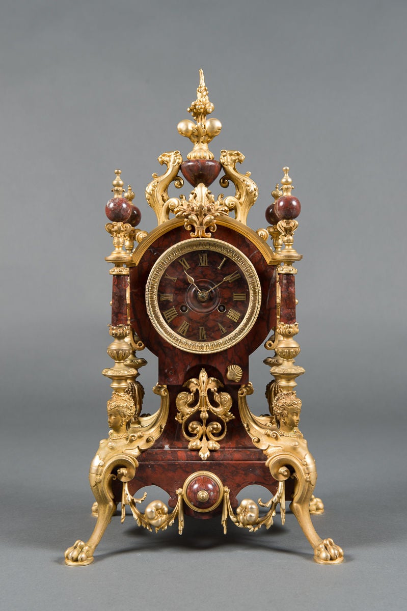 A 19th Century French Rouge Marble & Gilt Bronze 3-Piece Clock Garniture

Circa 1870

Origin: France

Clock
Height: 21.5