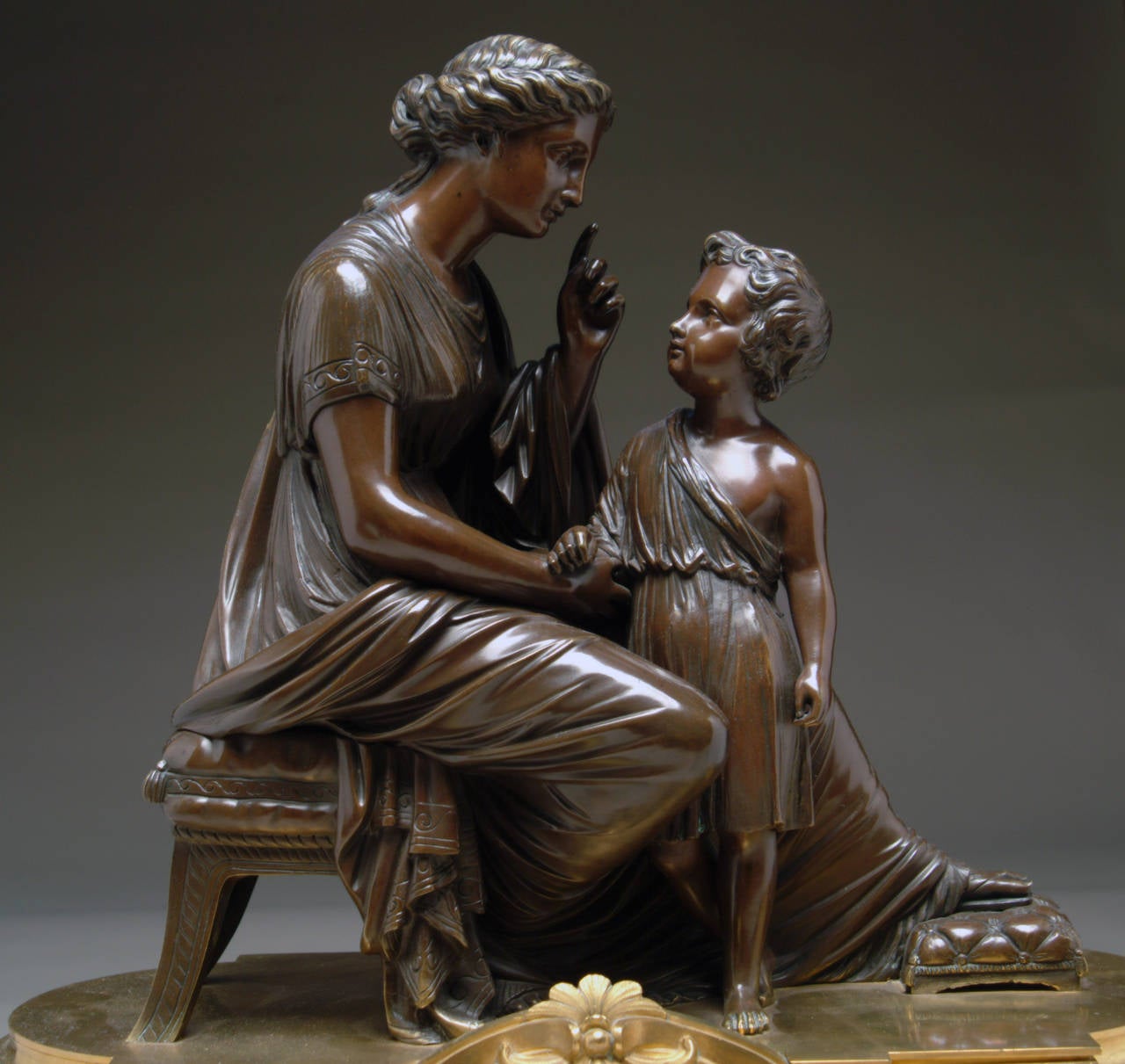 A magnificent 19th century French Louis XVI style gilt and patinated bronze clock depicting mother and child, by Raingo Frères, Paris.

The dial marked: Raingo Fres, A Paris.

Circa 1870

Height: 19.5