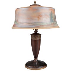 A Reverse Painted Pairpoint Landscape Lamp with Carved Wooden Base