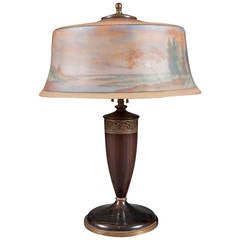 A Reverse Painted Pairpoint Landscape Lamp with Carved Wooden Base