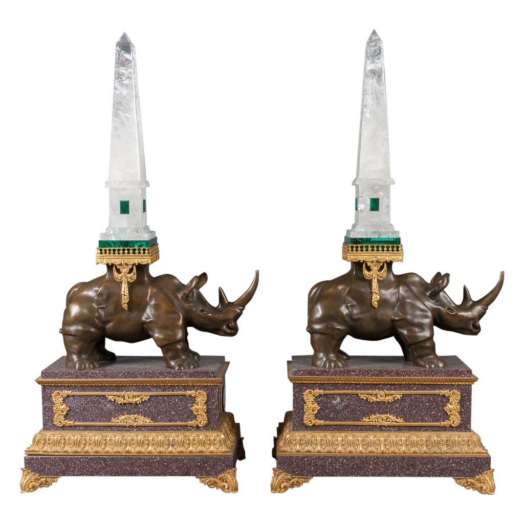 A large and impressive pair of rock crystal and malachite obelisks atop patinated bronze rhinoceros mounted on marble bases with inset round micromosaic plaques on gilt bronze feet.

Height: 46