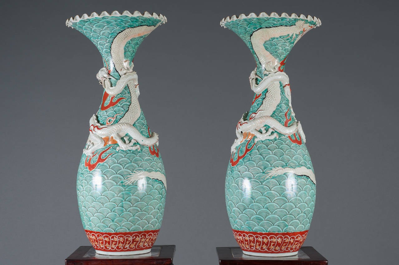 A Pair of 19th century Japanese Kutani Porcelain baluster Vases with Nishikigoi (koi) Motif. Each of baluster form with a flared ruffled mouth, beautifully decorated with red coy fish and an entwined dragon.  

Height: 29.5