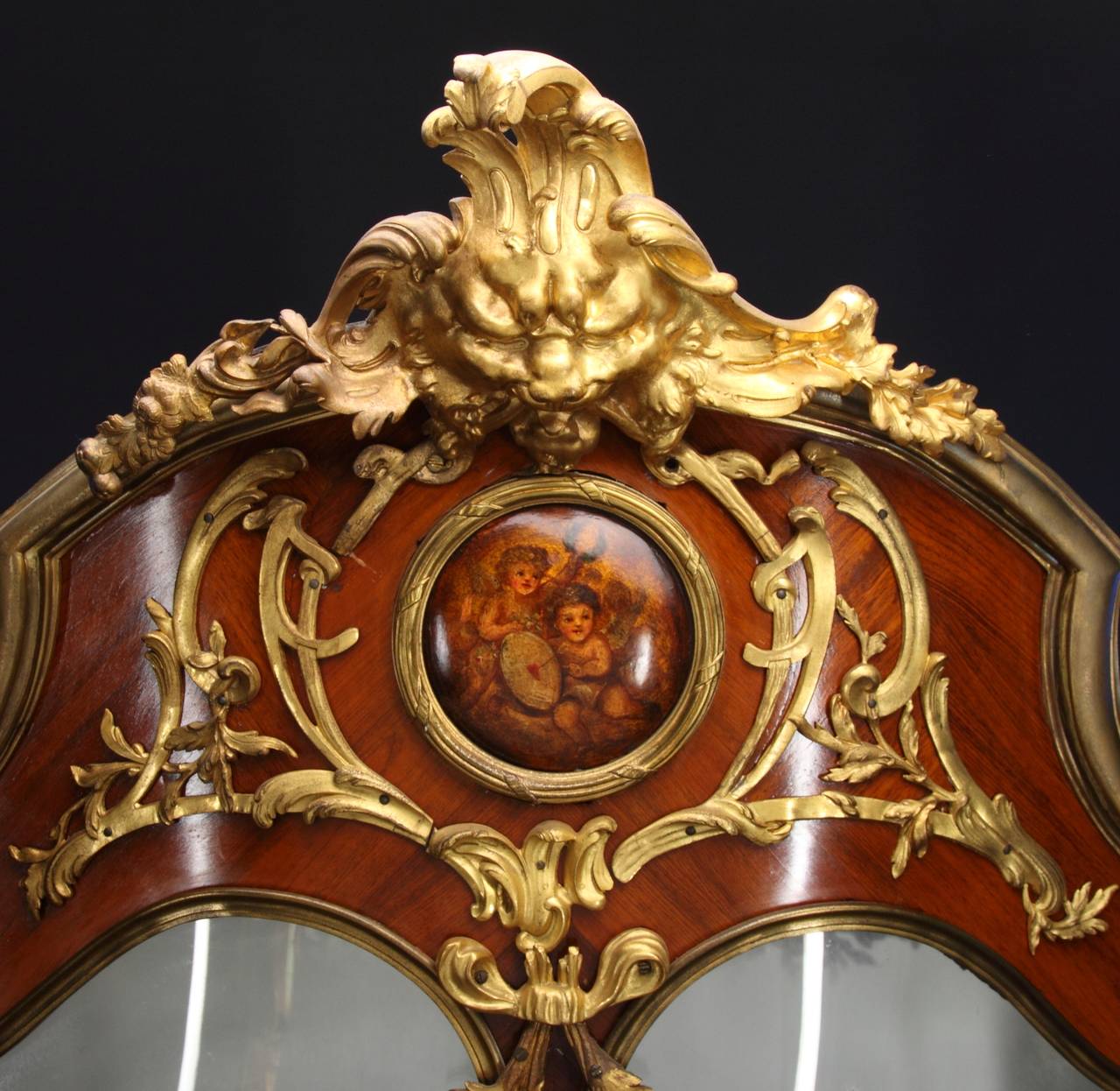 A Very Fine French 19th Century Ormolu-Mounted Louis XV Style Double-Door Vitrine attributed to Francois Linke. The front bombe Vernis Martin panel decorated with a painted scene with two female busts on either side, both doors with marquetry inlay