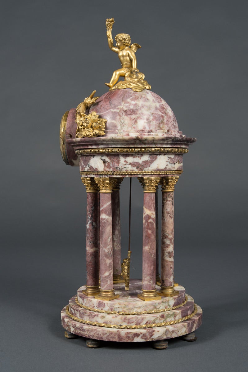 An elegant 19th century ormolu mounted marble 3 piece clock garniture.
This clock set was made in France for Tiffany & Company in the late 19th century. 
The set comprised of a clock and a pair of seven arms candelabras. The clock mounted with a