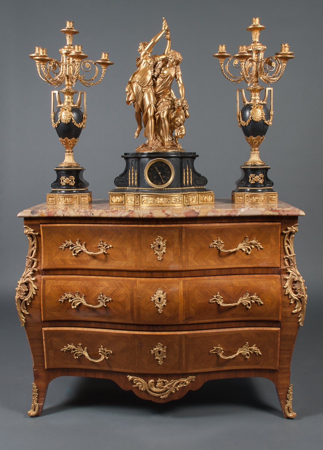 A French Napoleon III Ormolu & Marble Three Piece Garniture After Clodion C.1870

France, Circa 1870

Dimensions of Clock: Depth: 11