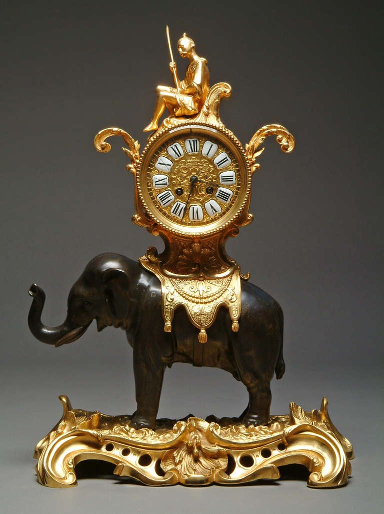A magnificent 19th century French mantle clock featuring a patinated bronze figure of a elephant with saddle surmounted with circular clock and seated chinoiserie figure on C-scroll base.
The clock movement stamped: E. P. Depose 7216.
