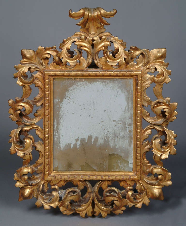 A very fine 19th century Italian carved wood mirror, having a vertical rectangular plate within a scrolling foliate giltwood frame.