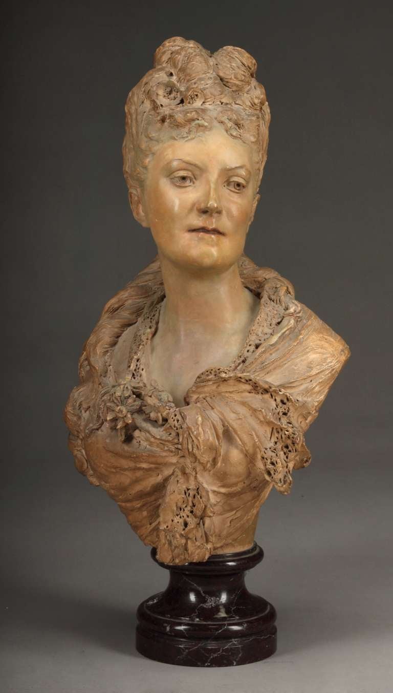 French Terracotta Bust of a lady on a Burgundy marble socle. 
Signed: A. Carrier
Circa 1860

Albert Ernest Carrier-Belleuse (1824-1887)
Carrier-Belleuse was a student of David d'Angers and briefly at the École des Beaux-Arts. His career is