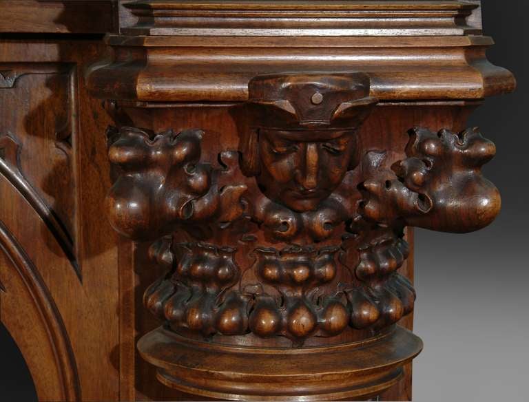 A monumental superb quality 19th century British Gothic style carved walnut and polychrome decorated fireplace. The masterfully hand carved fireplace is of solid walnut.

This Gothic style fireplace can bring a great sense of history into your