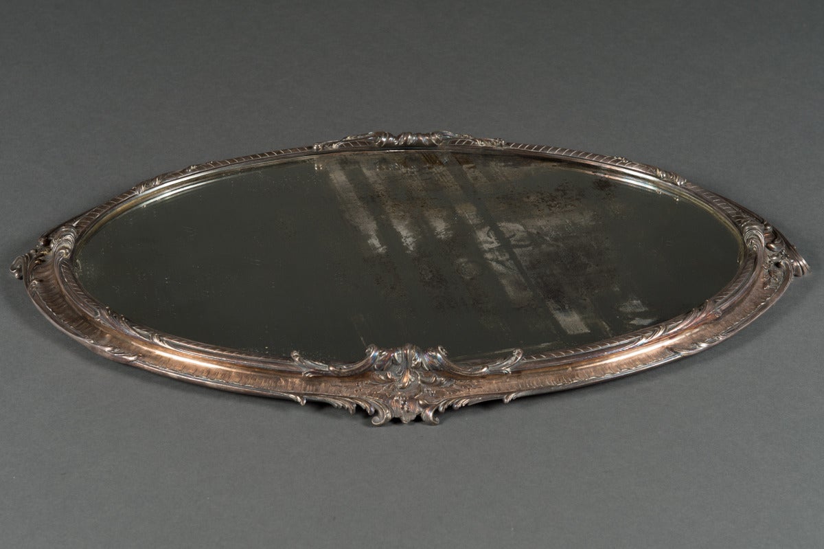A Christofle silvered bronze centerpiece and mirrored tray.

Dimensions: Height 11