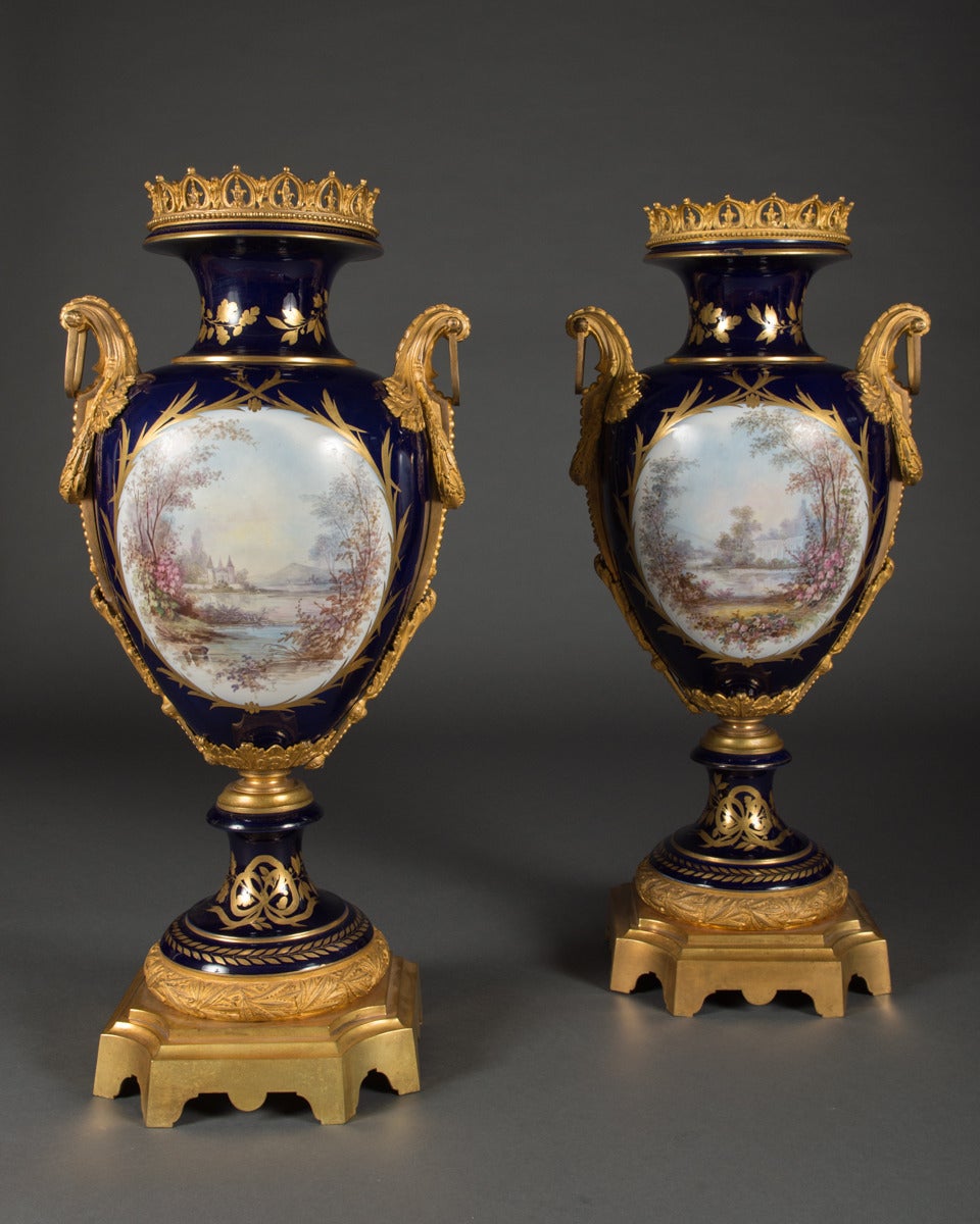A Pair of Large 19th Century French Sevres Style Ormolu Mounted and Painted Vases

Each in baluster form with large ormolu mounts. The body finely painted depicting a man & women in 18th century attire. The reverse painted with lakeside views