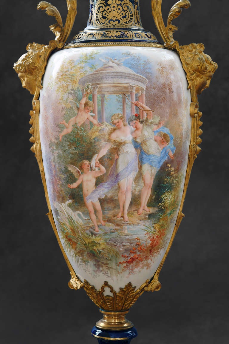 A magnificent palace size 19th century French ormolu mounted Sevres style porcelain covered vase. Painted on a white porcelain body centered with a Bouguereau style painting of two female beauties encompassed by three cupids in a mythical garden