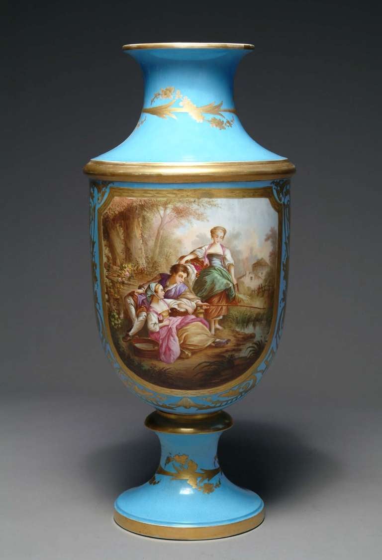 A 19th century French Sevres style turquoise porcelain vase.

Front hand-painted with a romantic scene and the back with a landscape.

Height: 31