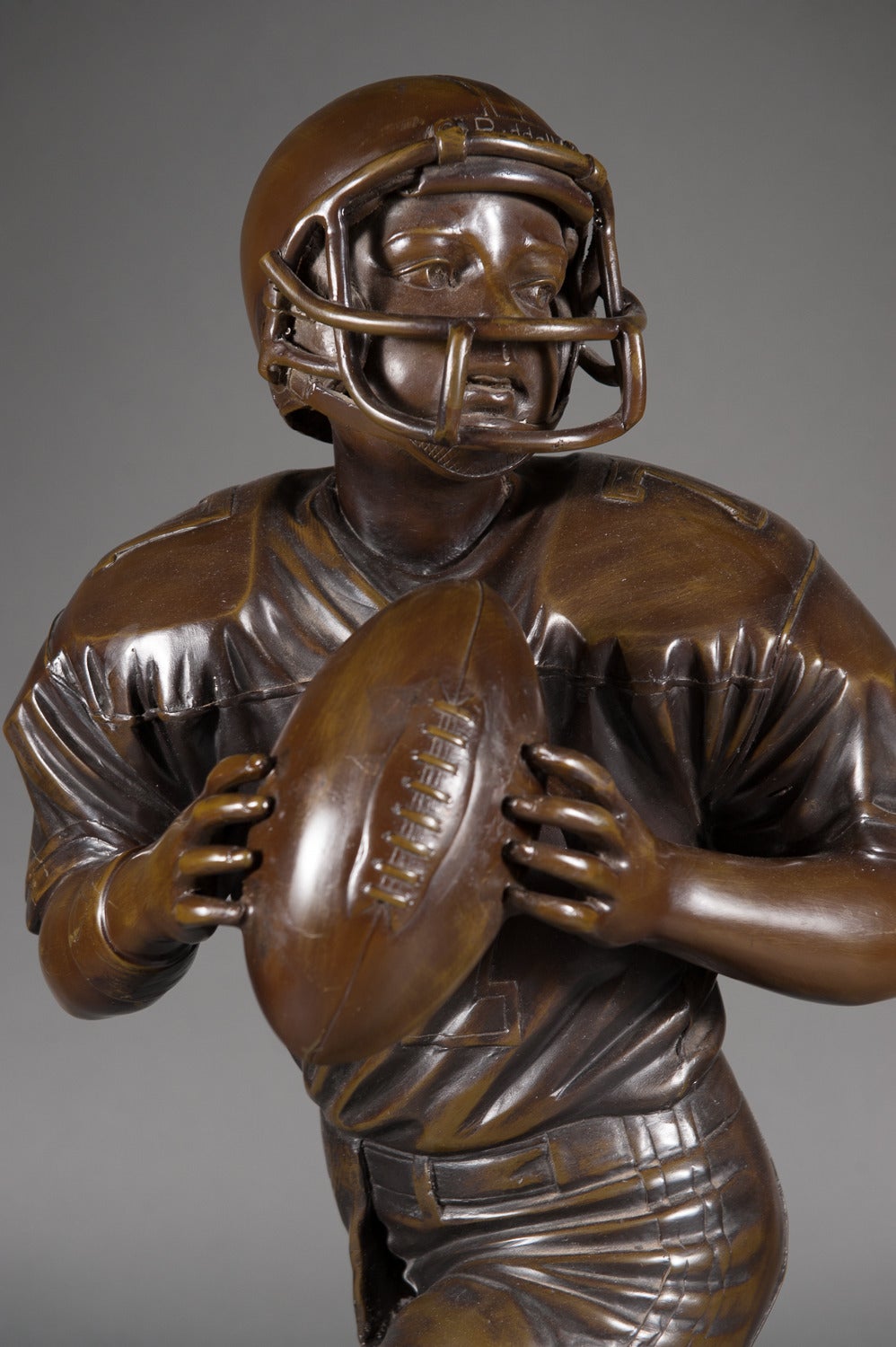Contemporary Bronze Sculpture of a Young Football Player. 
Signed Jim Davidson

Height: 41