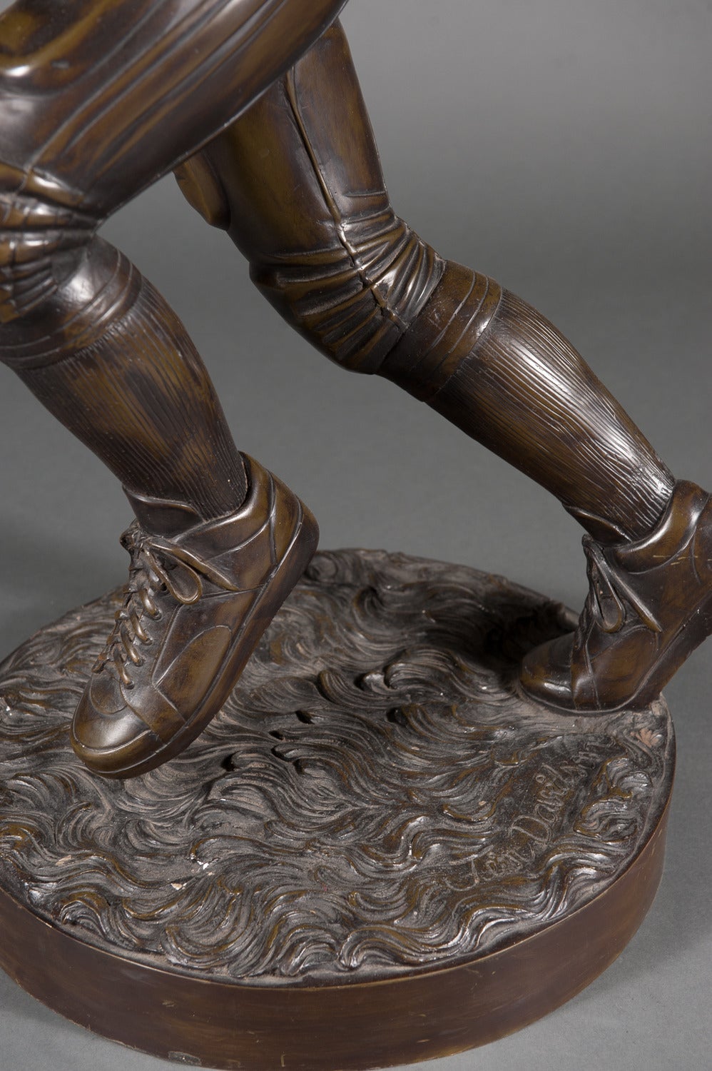 bronze football player statue