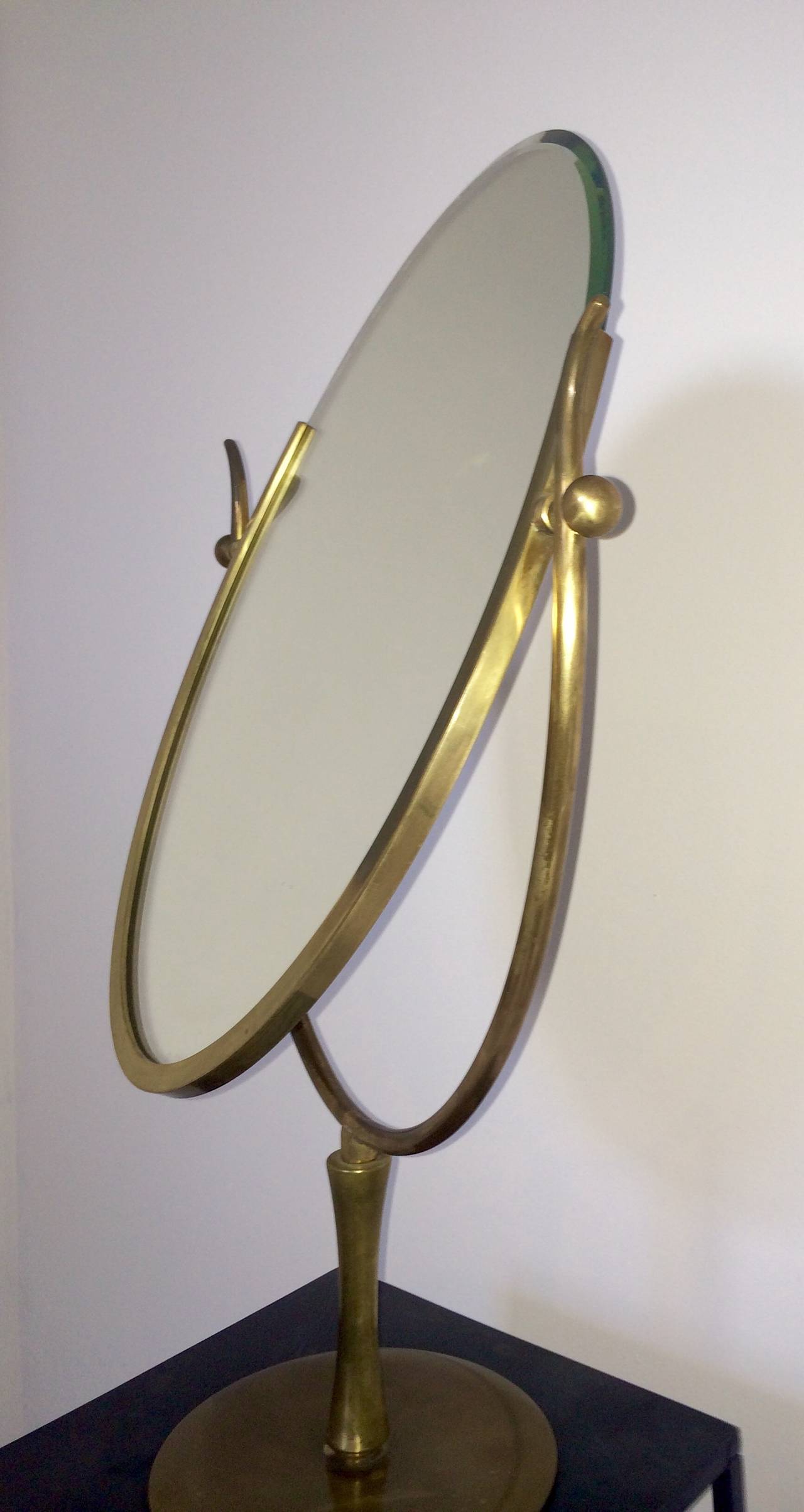 Elegant bronze table-mirror with adjustable swivel.  American, 1950s. Base diameter is 8.25 inches.