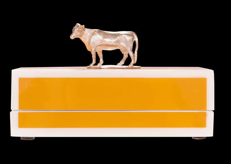 Bright yellow lacquer butter dish and lid, adorned with a solid, cast silver cow. Decorative, fun, colourful and practical – all the CRAWFORD hallmarks.