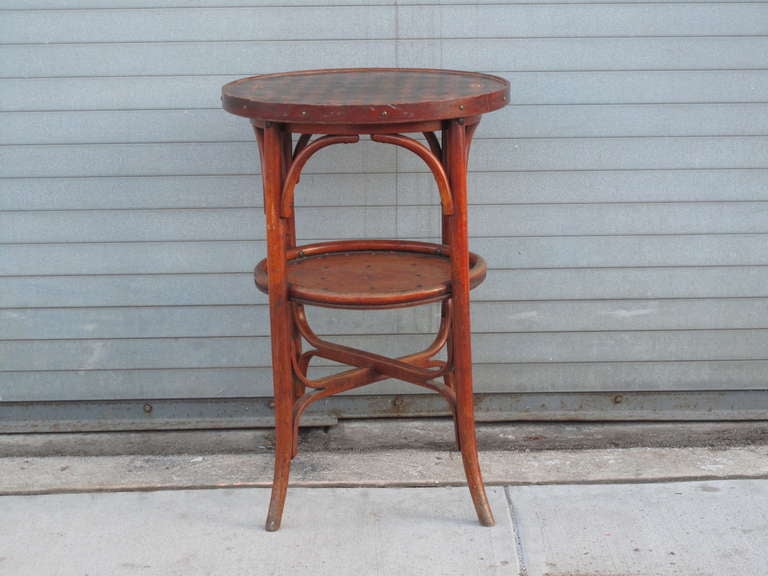 Cafe table in the manner of Thonet with diamond patterned surface.  Bentwood legs and base.  Perforated lower tier.  No visible labels or makers marks.