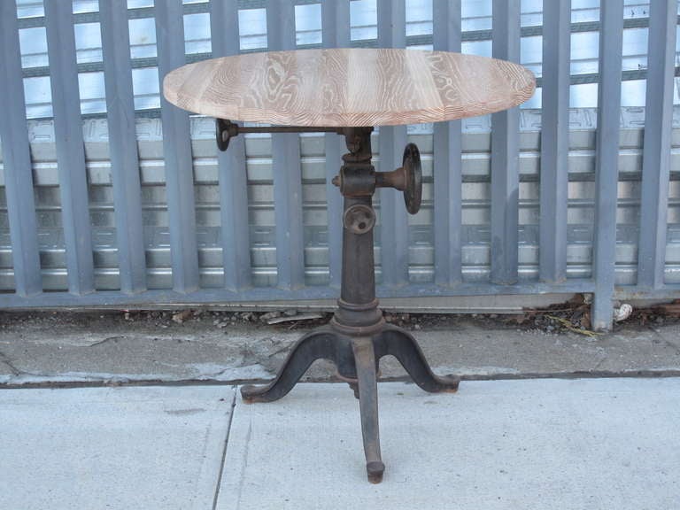 Cast iron industrial pedestal base with a limed oak round top.