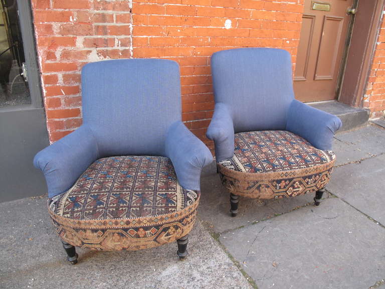 19th century antique French chairs with petite scroll arms.  Turned and ebonized front legs.  Cornflower blue linen/cotton upholstery with antique kilim seats.